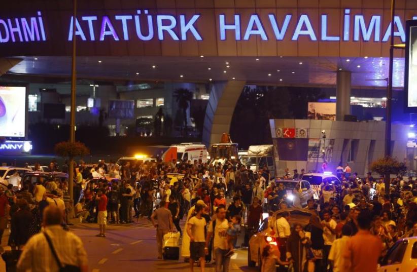 People leave Turkey's largest airport, Istanbul Ataturk, Turkey, following a blast June 28, 2016. (photo credit: REUTERS)