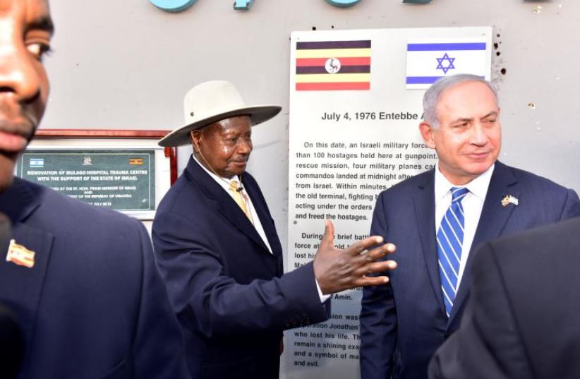 Uganda's President Yoweri Museveni (L) speaks to Israeli Prime Minister Benjamin Netanyahu (R) during a memorial service to commemorate the 40th anniversary of Operation Entebbe at the Entebbe airport in Uganda, July 4, 2016.  (photo credit: REUTERS)