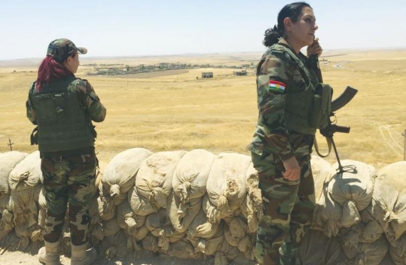 PESHMERGA FIGHTERS stand guard at a checkpoint near Mosul Dam on the Tigris River in Kurdistan.  (photo credit: SETH J. FRANTZMAN)