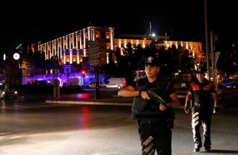 Police officers stand guard near the Turkish military headquarters in Ankara, Turke (photo credit: REUTERS)