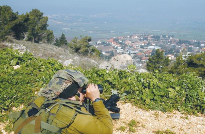 A SOLDIER near Metulla monitors Lebanon (photo credit: REUTERS/BAZ RATNER)