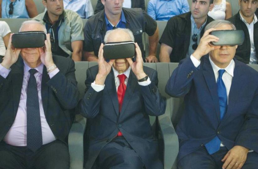 PRESIDENT REUVEN RIVLIN, former president Shimon Peres, and Prime Minister Benjamin Netanyahu don virtual reality goggles at the Peres Center for Peace and Innovation in Jaffa (photo credit: REUTERS)