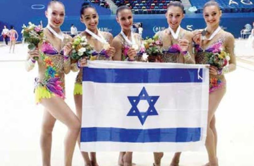 The members of Israel’s rhythmic gymnastics national team pose with the gold medals they won yesterday in the ribbons final at the World Cup competition in Baku, Azerbaijan. (photo credit: (OLYMPICS COMMITTEE OF ISRAEL/COURTESY)‏)