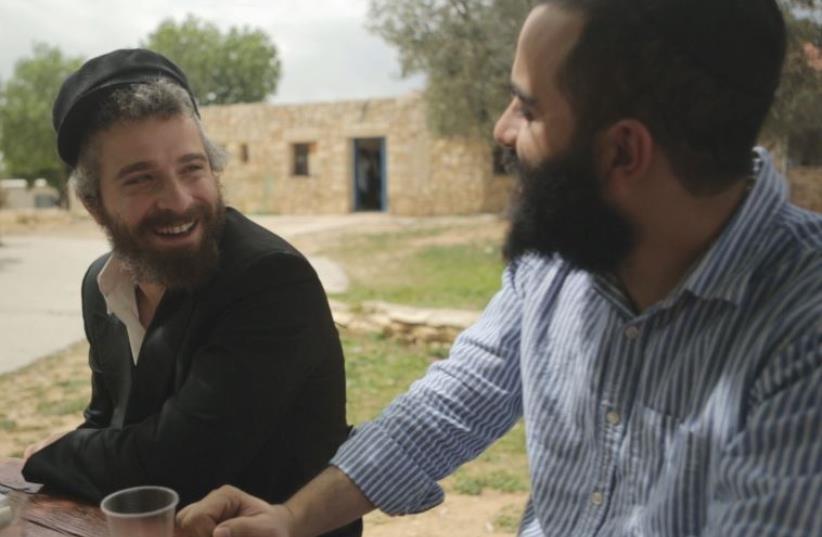 ELAD NEHORAI (right) speaks to a Bat Ayin resident in March. (photo credit: Courtesy)