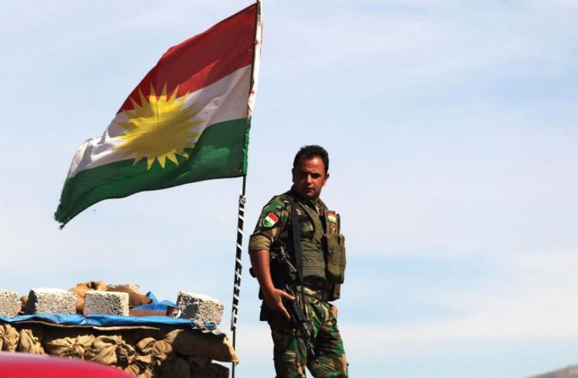 A KURDISH peshmerga soldier stands at a lookout near Bashiqa in northern Iraq (photo credit: REUTERS)