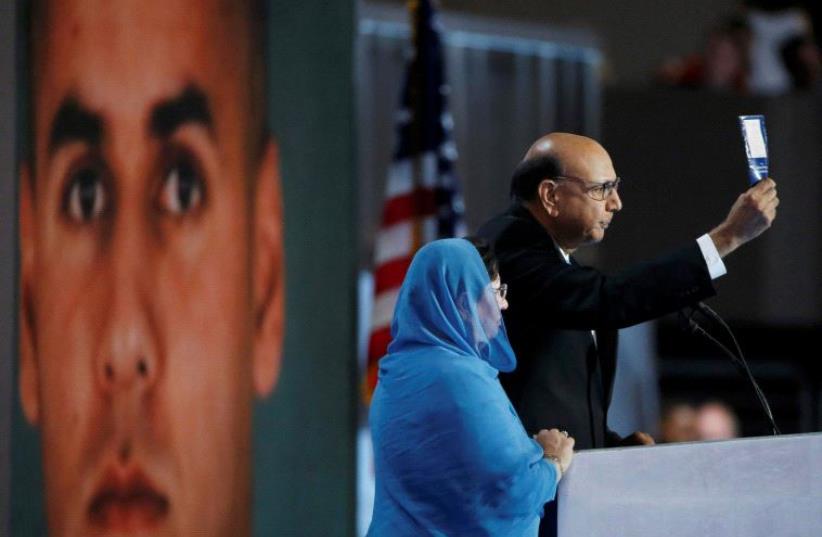 Khizr Khan, who's son Humayun (L) was killed serving in the US Army, challenges Republican presidential nominee Donald Trump to read his copy of the US Constitution, at the Democratic National Convention in Philadelphia, Pennsylvania July 28, 2016 (photo credit: REUTERS)