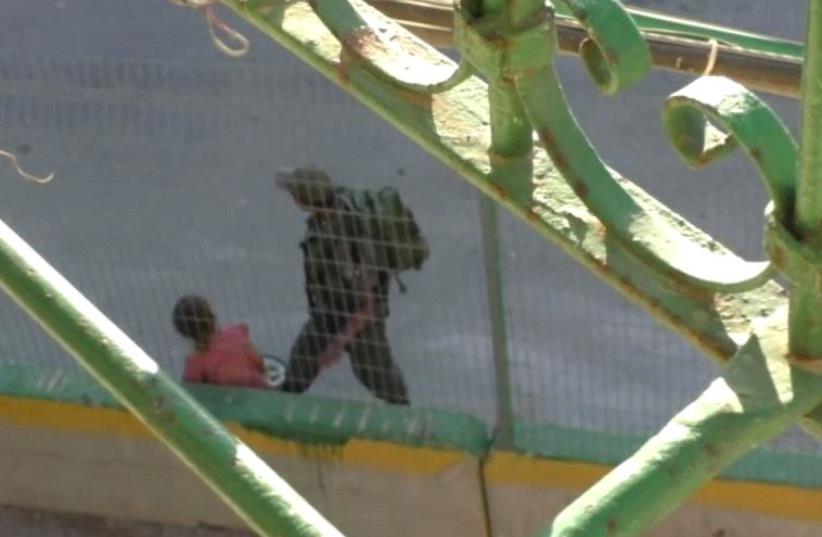 Screenshot of B'tselem video in which Border Policeman seen confiscating Palestinian girl's bike (photo credit: screenshot)