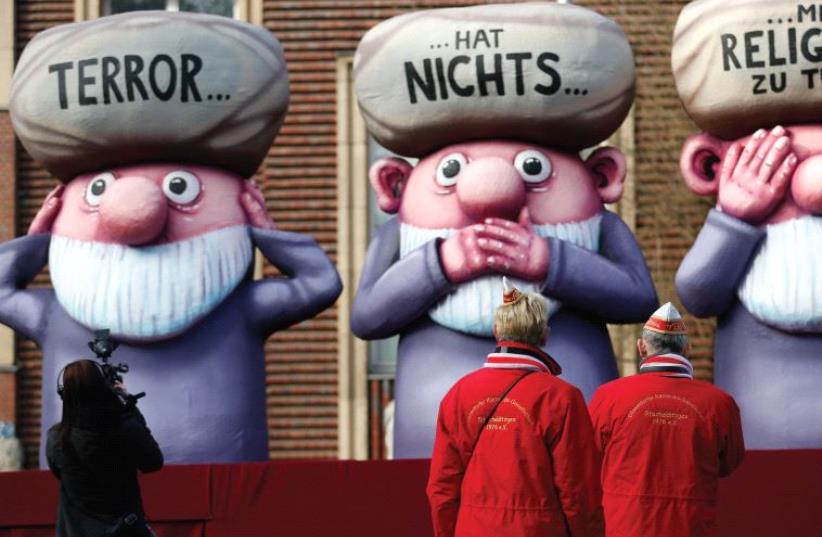 THIS FLOAT at a German parade has the words ‘Terror has nothing to do with religion’ written on three mullahs (monkeys). ( (photo credit: REUTERS)