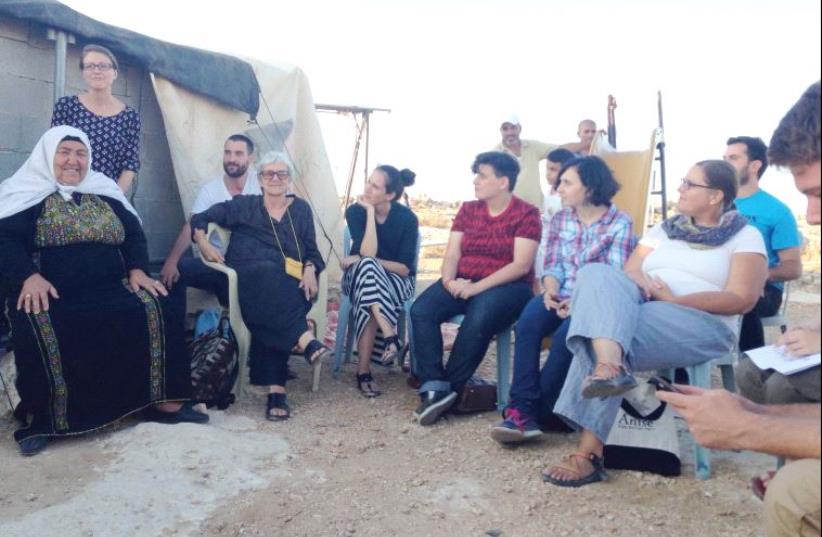 Jewish participants gather after listening to Palestinian residents of Sussiya discuss their narrative of the village (photo credit: ELIYAHU KAMISHER)