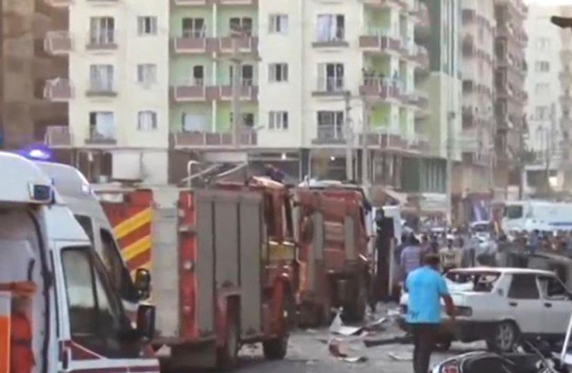 A still image taken from a video footage shows emergency vehicles at the scene of a bomb blast in Kiziltepe, Turkey (photo credit: REUTERS)
