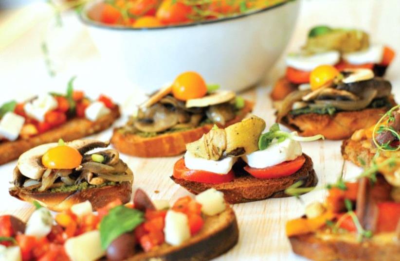 Bruschetta with tomatoes, basil and salty cheese (photo credit: PASCALE PEREZ-RUBIN)