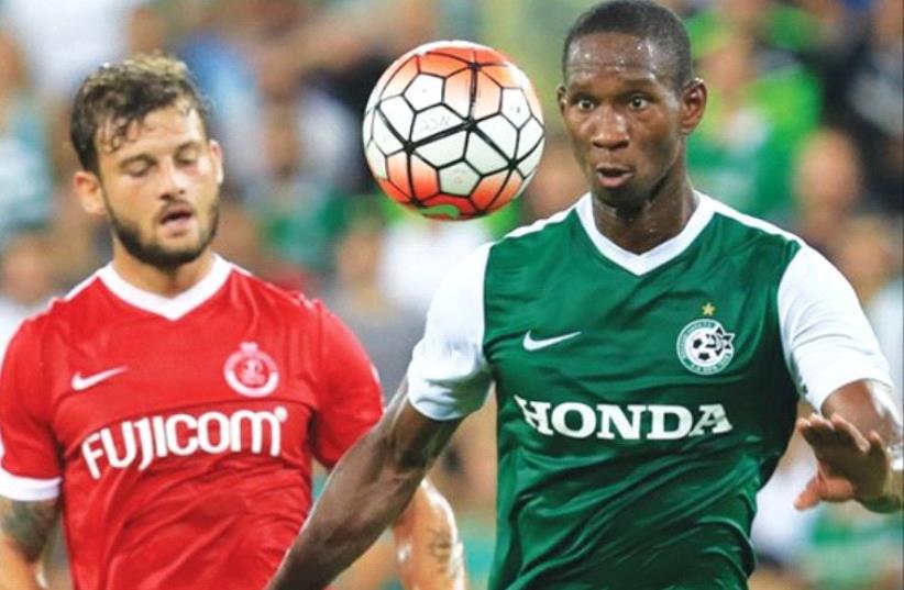 Maccabi Haifa striker Glynor Plet (right) scored the winner in last night’s 1-0 win over Adi Gotlieb (left) and Hapoel Tel Aviv at Haifa Stadium. (photo credit: ERAN LUF)