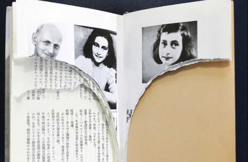 RIPPED PAGES of Anne Frank’s ‘Diary of a Young Girl’ are pictured at a library in Tokyo. (photo credit: REUTERS)
