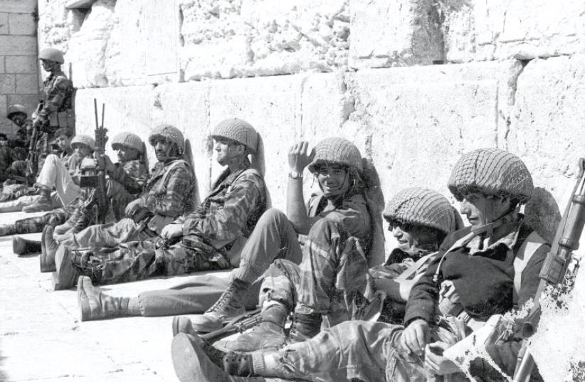 IDF Paratroopers relax after liberating the Western Wall during the Six Day War (photo credit: IDF SPOKESMAN’S UNIT)