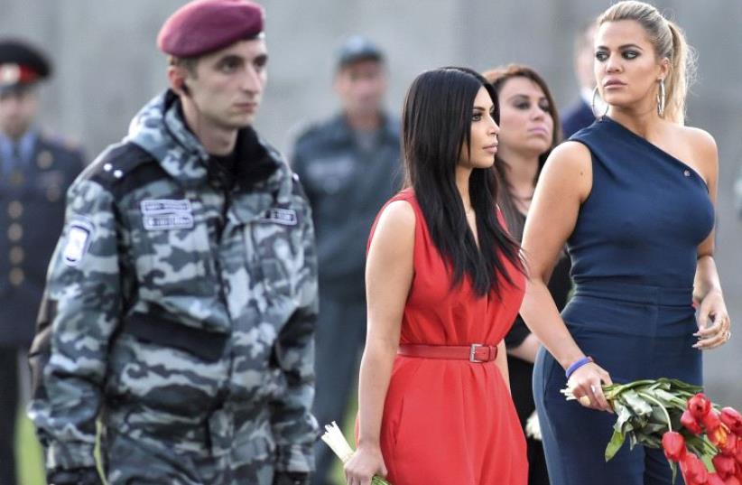 US television personality Kim Kardashian (C) and her sister Khloe Kardashian attend a flower laying ceremony at the Tsitsernakaberd Armenian Genocide Memorial Museum in Yerevan (photo credit: REUTERS)
