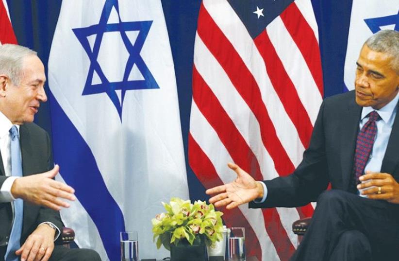 A SMILING Prime Minister Benjamin Netanyahu reaches out to shake the hand of an aloof President Barack Obama during their meeting Wednesday in New York. (photo credit: REUTERS)
