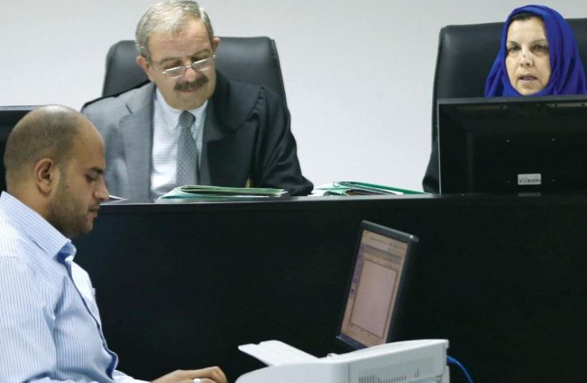 Palestinian judges discuss a petition to suspend municipal elections, at the High Court office in Ramallah on September 8 (photo credit: REUTERS)