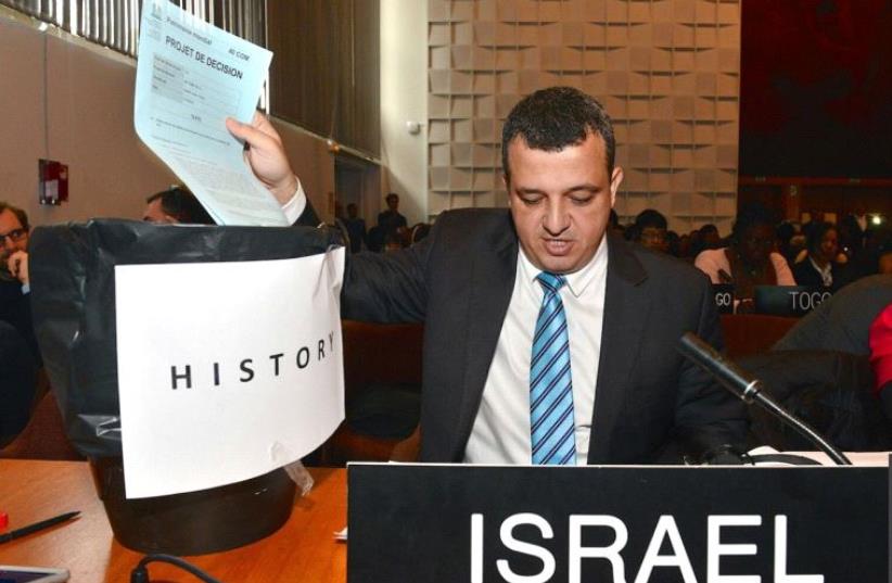 Israel's envoy to UNESCO Carmel Shama-Hacohen puts the resolution on Jerusalem in the trashbin of history (photo credit: EREZ LICHTFELD / PERMANENT MISSION OF ISRAEL TO THE UN)