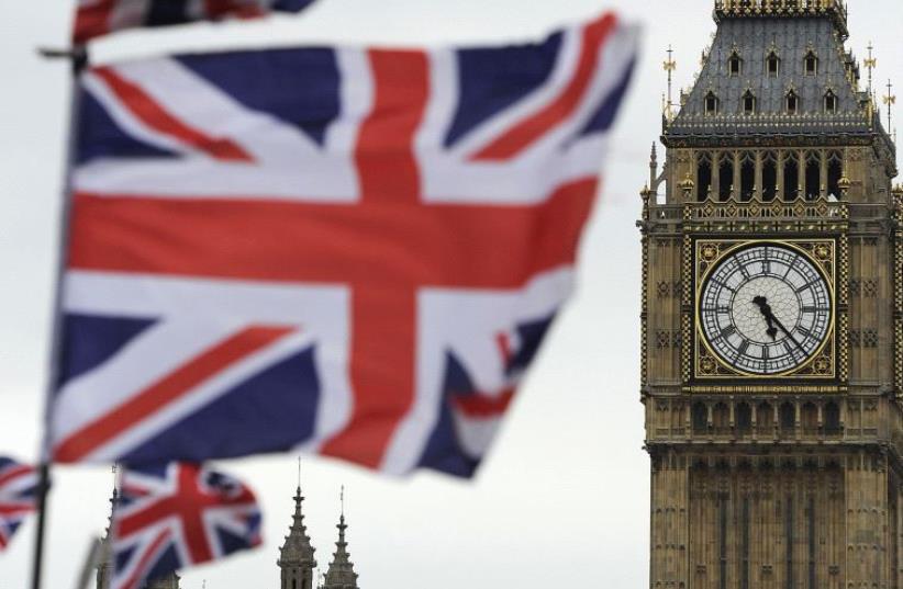 Flags are seen above a souvenir kiosk near Big Ben clock at the Houses of Parliament in central London (photo credit: REUTERS)