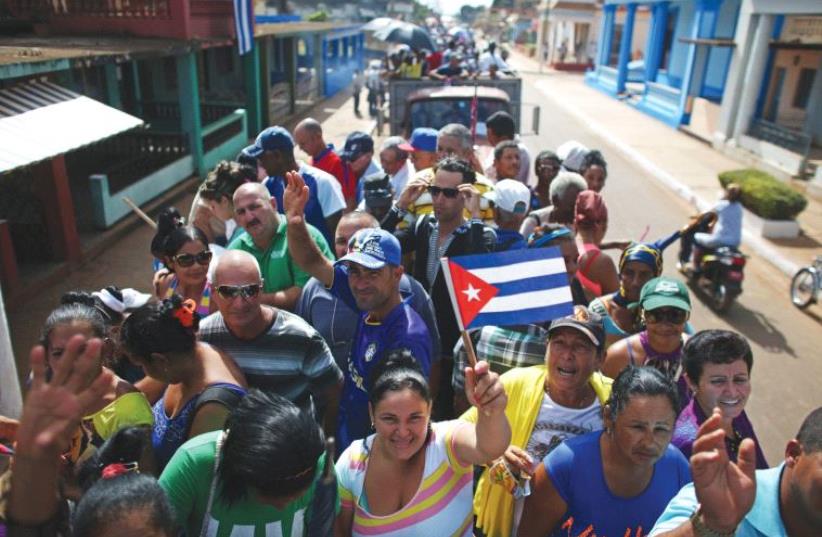 PEOPLE ARE transported to greet the caravan carrying the ashes of Fidel Castro in Colon, Cuba, on Wednesday. (photo credit: REUTERS)