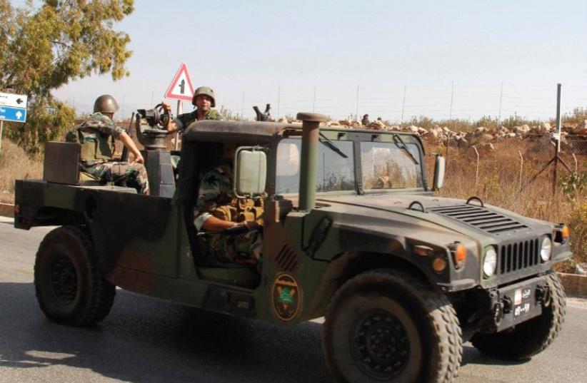 LEBANESE SOLDIERS drive near the border with Israel in Kafr Kila, in October. Israel has used its ability to operate in the skies over Syria to prevent weapons transfers to Hezbollah in Lebanon from the Syrian regime. (photo credit: REUTERS)