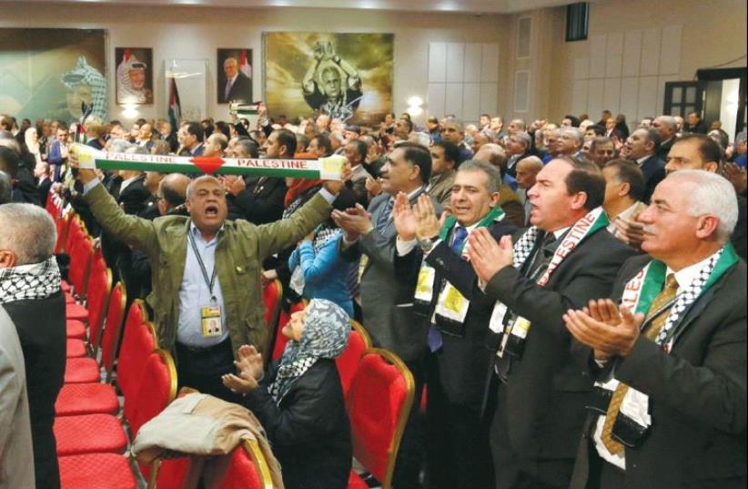 PARTICIPANTS IN the Fatah congress in Ramallah clap and cheer before a speech by Palestinian Authority President Mahmoud Abbas. (photo credit: REUTERS)