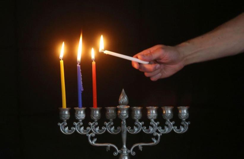 Lighting of the Hanukkah menorah  (photo credit: MARC ISRAEL SELLEM/THE JERUSALEM POST)