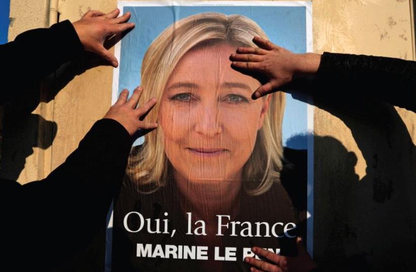 SUPPORTERS OF Marine Le Pen put up a poster earlier this year. There has been a meteoric rise of right-wing movements in Europe, writes the author. (photo credit: REUTERS)