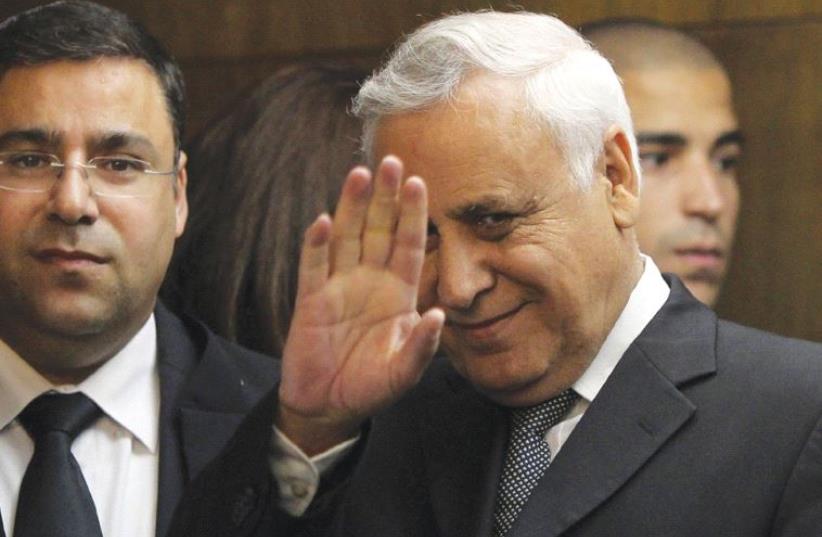 FORMER PRESIDENT Moshe Katsav waves to the press as he enters Tel Aviv District Court on December 30, 2010, to hear himself pronounced guilty of rape charges. (photo credit: REUTERS)