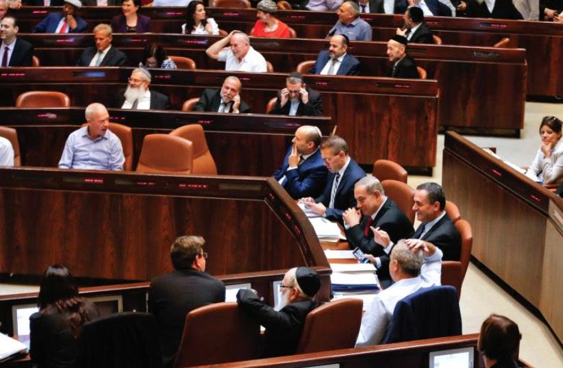 SHOW US the money. Lawmakers attend a preliminary vote on a bill at the Knesset (photo credit: REUTERS)