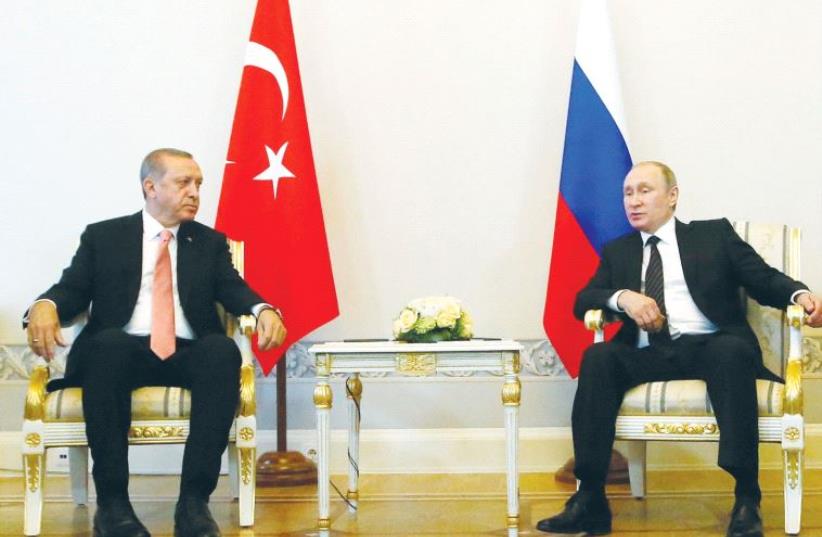 RUSSIAN PRESIDENT Vladimir Putin (right) speaks to Turkish President Recep Tayyip Erdogan during their meeting in St. Petersburg, Russia, in August. (photo credit: REUTERS)