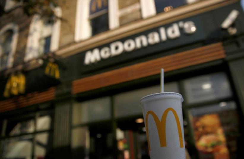 A branded soft drink sits outside a McDonald's restaurant in London, Britain December 9, 2016 (photo credit: REUTERS)