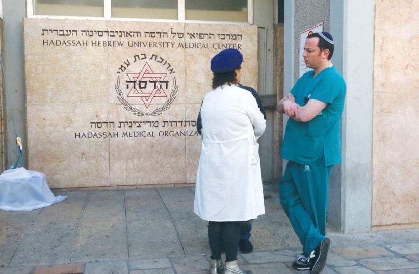 MEDICAL STAFFERS at Jerusalem’s Hadassah-University Hospital in Ein Kerem discuss yesterday’s call to strike. (photo credit: MARC ISRAEL SELLEM/THE JERUSALEM POST)