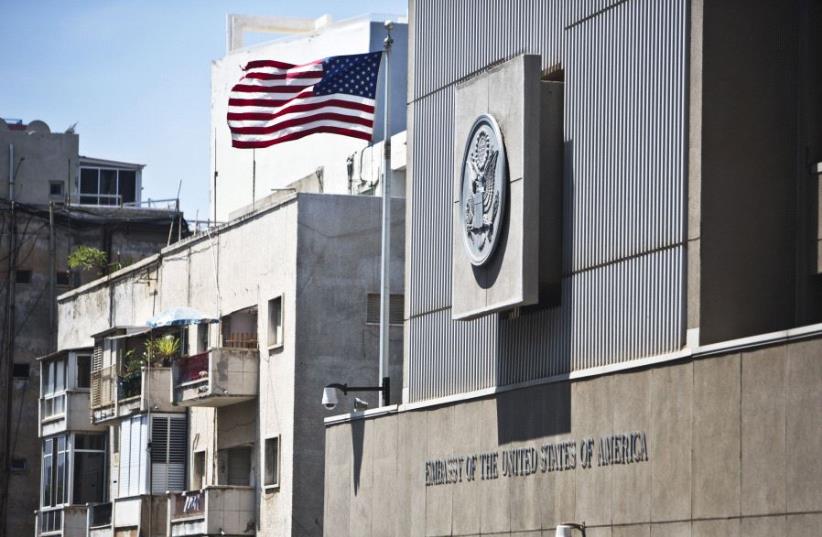 A flag flutters outside the US embassy in Tel Aviv August 4, 2013 (photo credit: REUTERS)