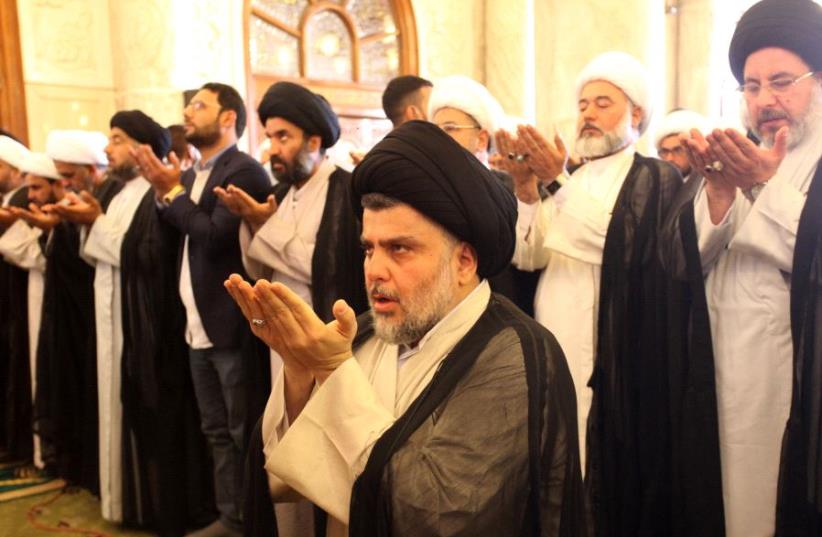 Iraqi Shi'ite radical leader Moqtada al-Sadr (C) takes part in Friday prayers at the Kufa mosque near Najaf, Iraq . (photo credit: REUTERS)