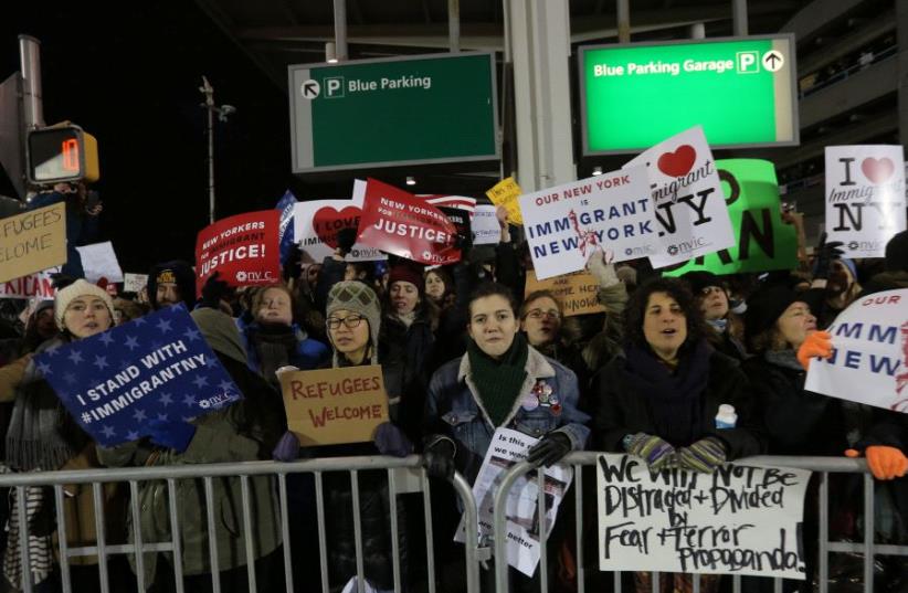 Protesters gather outside Terminal 4 at JFK airport in opposition to U.S. president Donald Trump's proposed ban on immigration in Queens, New York City, US, January 28, 2017 (photo credit: REUTERS)