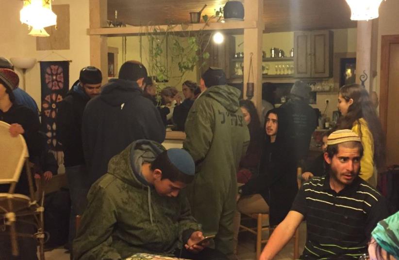 At least 20 teenagers in one Amona home. Playing guitar and just waiting for the evacuation. (photo credit: ANNA AHRONHEIM)