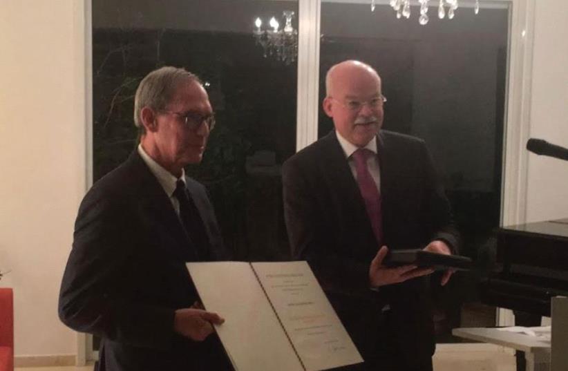 MK NACHMAN SHAI receives the Order of Merit of the Federal Republic of Germany from Ambassador Dr. Clemens von Goetze yesterday. (photo credit: Courtesy)