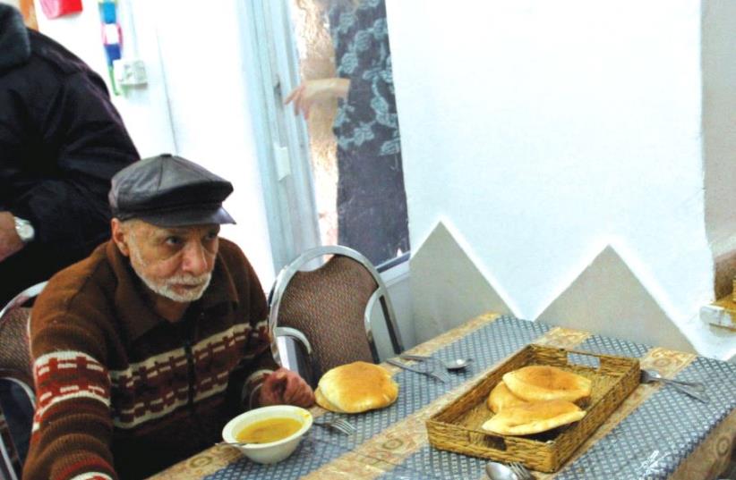 Bread is served at a soup kitchen in central Israel (photo credit: REUTERS)