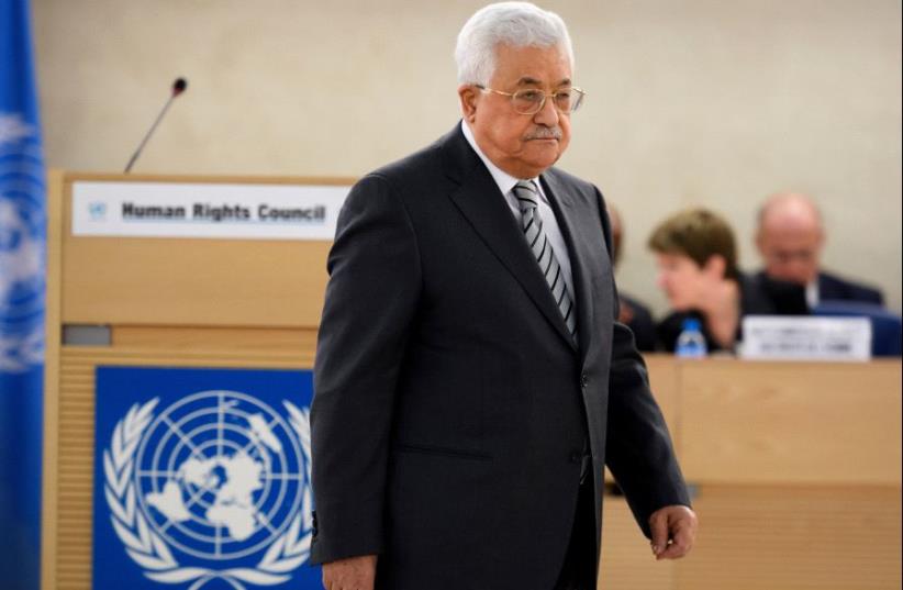 Palestinian President Mahmud Abbas arrives to delivers a speech during the United Nations Human Rights Council on February 27, 2017 in Geneva (photo credit: FABRICE COFFRINI / AFP)