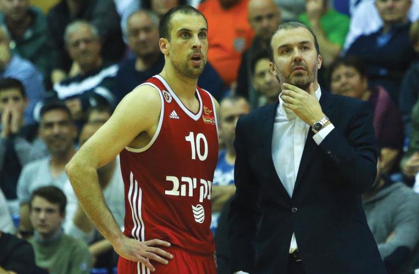 Hapoel Jerusalem coach Simone Pianigiani (right) and captain Yotam Halperin called on the team’s fans to pack the Jerusalem Arena tonight in Game 1 of the Eurocup quarterfinal series against Spain’s Gran Canaria.  (photo credit: UDI ZITIAT)