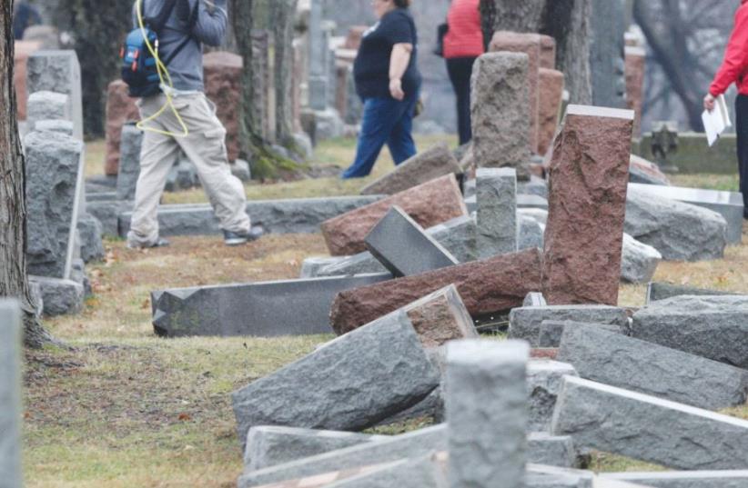 A ROW of more than 170 toppled Jewish headstones is seen after vandals attacked a Jewish cemetery near St. Louis, February 2017 (photo credit: REUTERS)