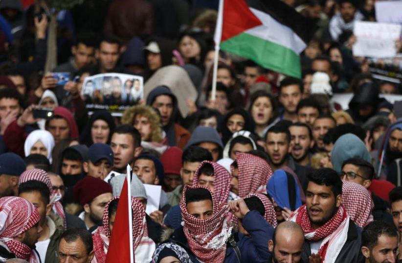 Palestinians demonstrate in the centre of the West Bank city of Ramallah against PA security forces (photo credit: ABBAS MOMANI / AFP)