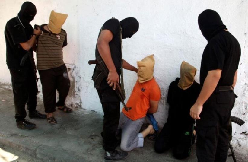 Hamas operatives prepare to execute alleged collaborators in the Gaza Strip (photo credit: REUTERS)