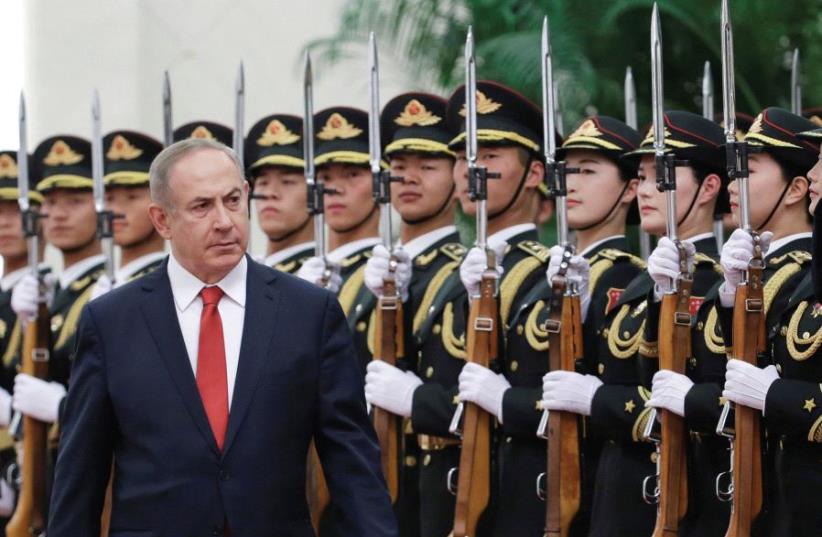PRIME MINISTER Benjamin Netanyahu inspects an honor guard in Beijing (photo credit: REUTERS)
