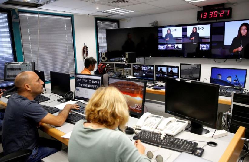 FILE PHOTO: Employees work in the offices of Kan, the new Israeli Public Broadcasting Corporation, in Tel Aviv, Israel November 3, 2016. (photo credit: REUTERS)