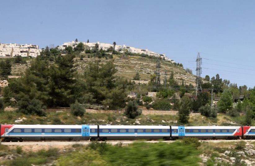 An Israel Railways train passes through Ein Yael in Jerusalem (photo credit: MARC ISRAEL SELLEM/THE JERUSALEM POST)