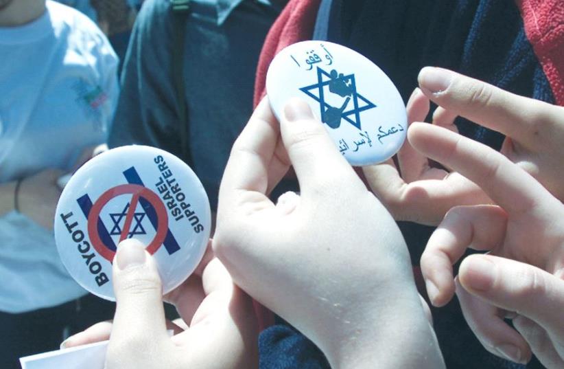 LEBANESE STUDENTS hand out buttons encouraging a boycott of Israel. (photo credit: REUTERS)