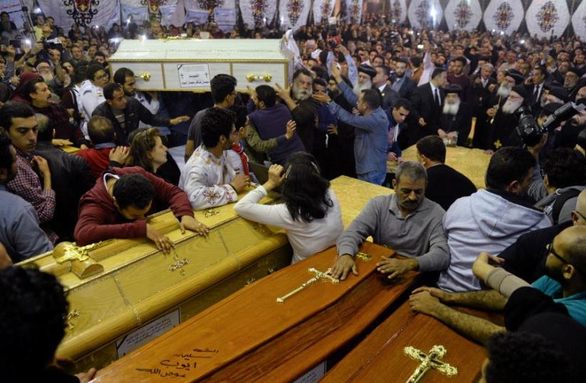 Relatives of victims react to coffins arriving to the Coptic church that was bombed on Sunday in Tanta, Egypt, April 9, 2017 (photo credit: REUTERS)