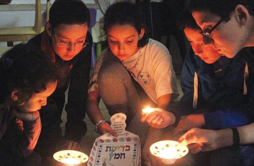 MEMBERS OF the Nataf family take part in ‘bedikat hametz’ ritual in Jerusalem. (photo credit: MARC ISRAEL SELLEM)